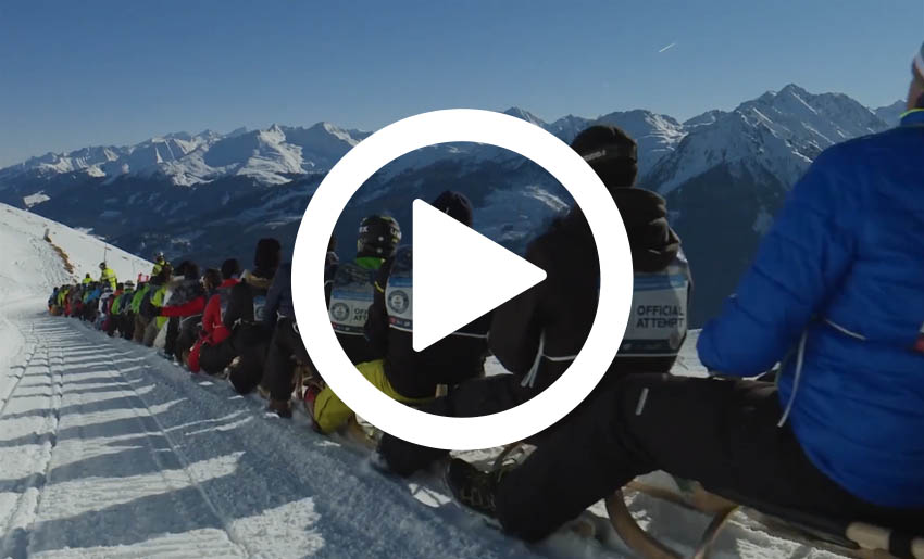 people on a sledge on a mountain