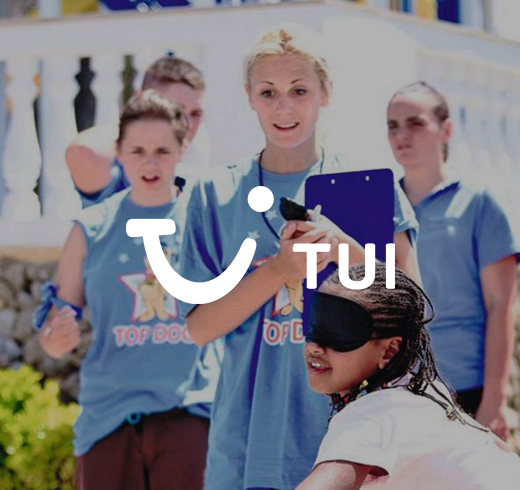 TUI - woman in blindfold and women behind her in blue t shirts