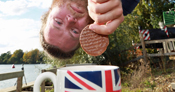 man dunking biscuit into mug