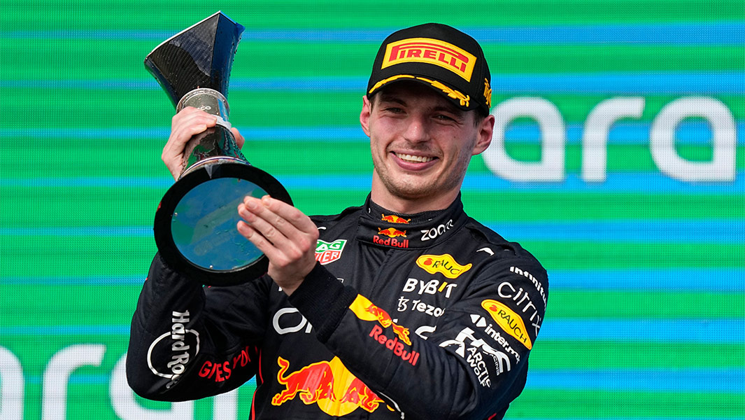 Max Verstappen smiling with cup