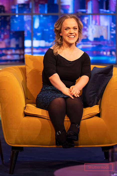 Ellie sitting down and smiling