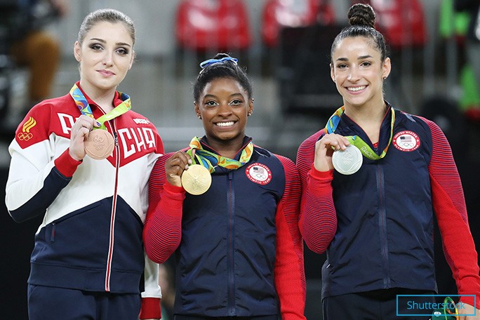 Simone showing off her gold medal. She is flanked by compatriot Alexandra Raisman (silver) and Aliya Mustafina (bronze) of Russia