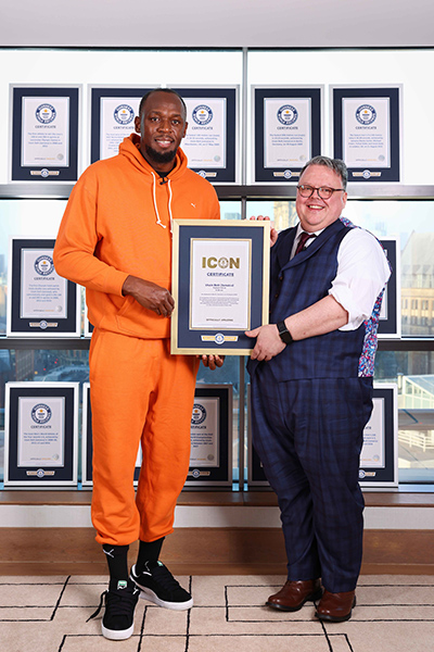 Bolt and craig holding certificate and smiling