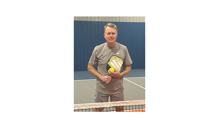 David Satka holding a pickleball and a paddle