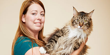 former longest cat being held by owner